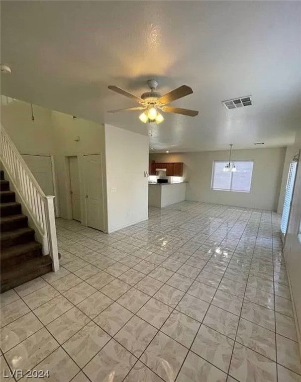 unfurnished room featuring ceiling fan and light tile flooring