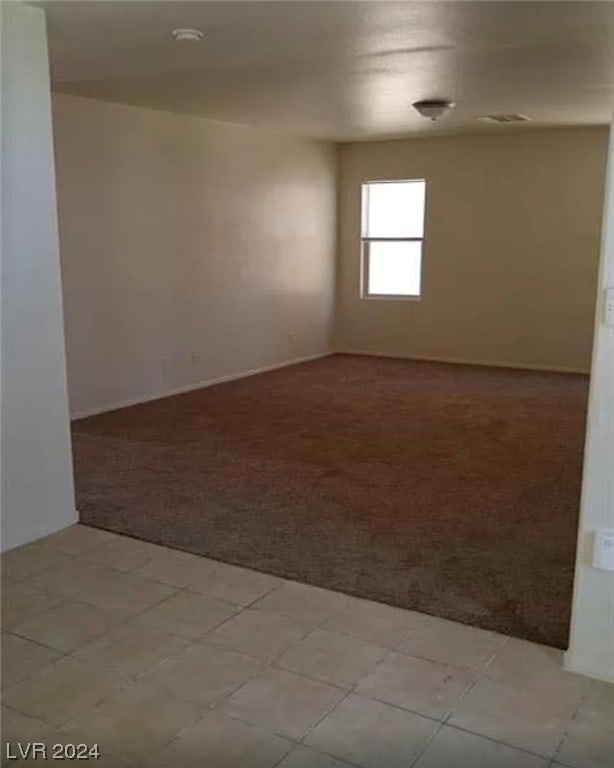 unfurnished room with light carpet