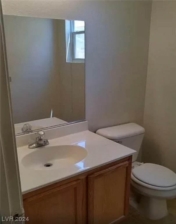 bathroom featuring toilet and vanity