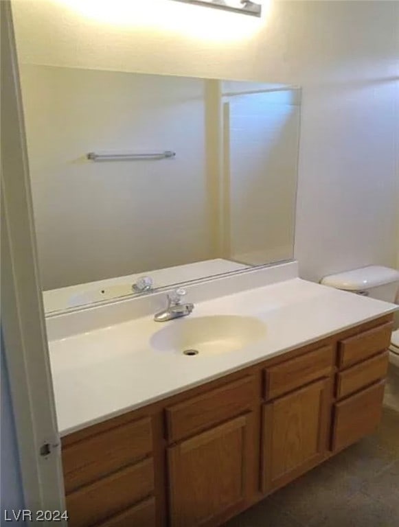 bathroom with tile floors, toilet, and vanity