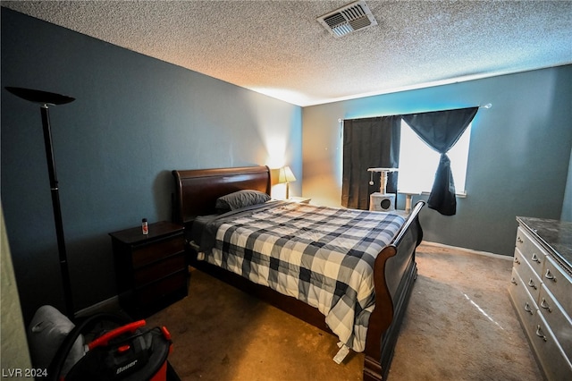 bedroom featuring dark colored carpet and a textured ceiling