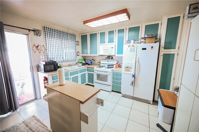 kitchen featuring white appliances and light tile floors