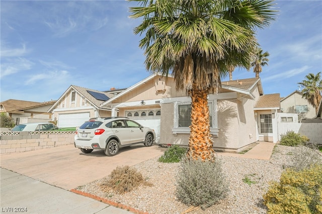 view of front of property with a garage and solar panels