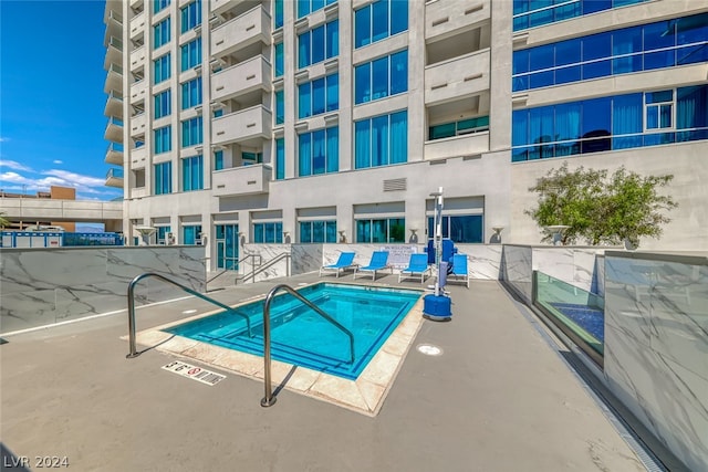 view of pool with a community hot tub