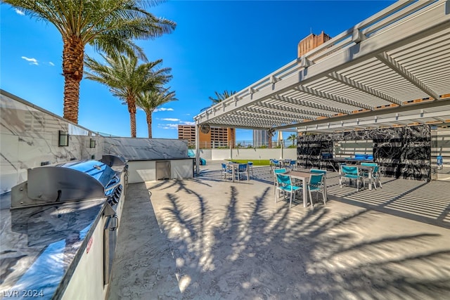 view of patio / terrace featuring a pergola and an outdoor kitchen