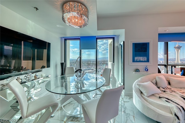 dining area featuring a notable chandelier and light tile floors