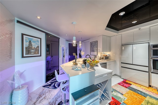 kitchen featuring light tile floors, pendant lighting, and stainless steel appliances