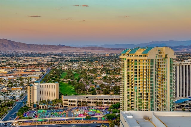 aerial view at dusk featuring a mountain view