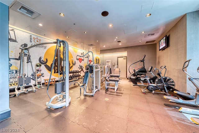 gym featuring light tile floors