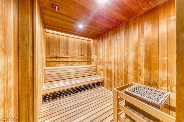 view of sauna / steam room featuring wood ceiling and wood walls