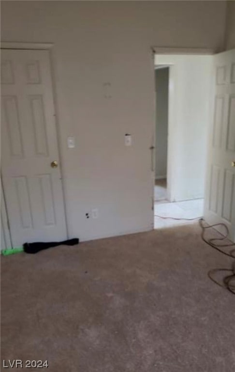 unfurnished room with light colored carpet