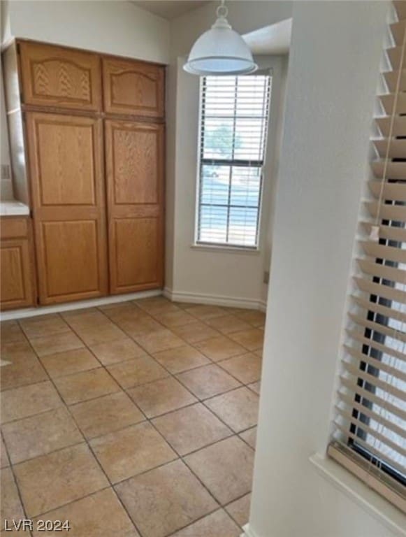 unfurnished bedroom with light tile flooring