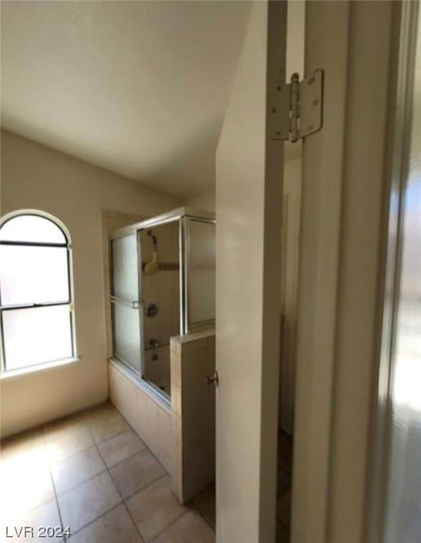 bathroom featuring tile floors and a shower with shower door