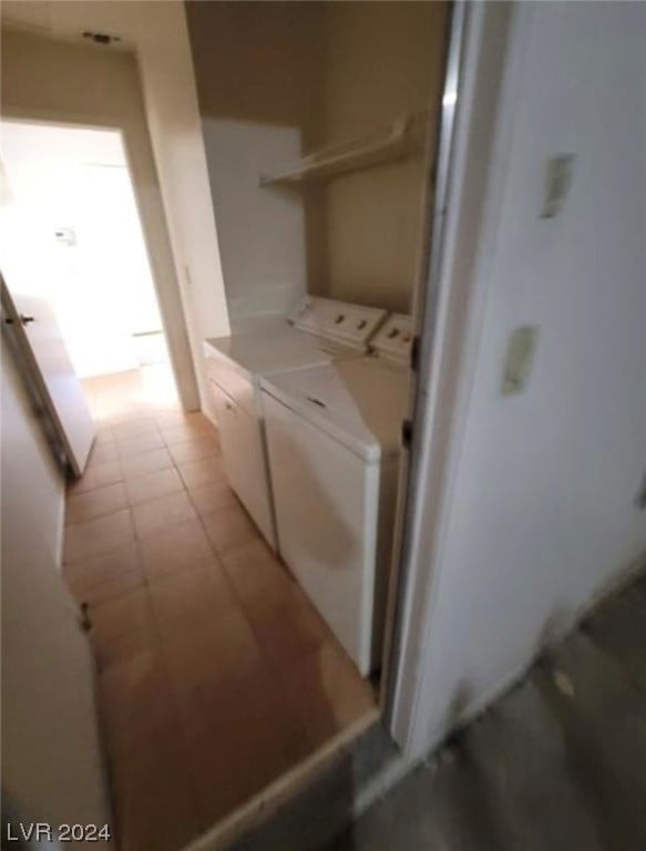 laundry area featuring separate washer and dryer and light tile flooring