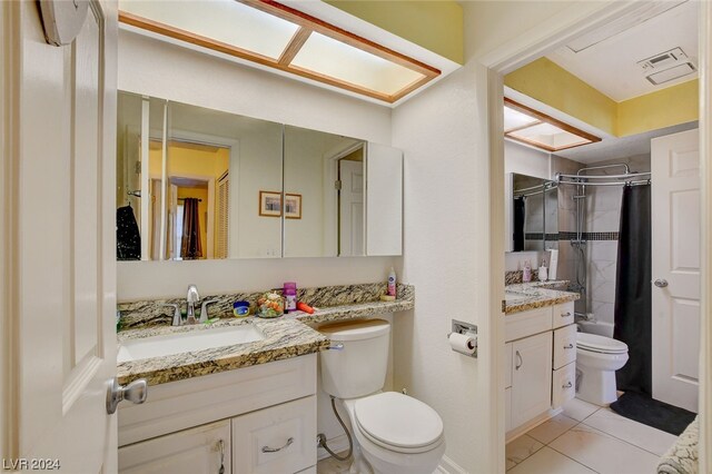 full bathroom with tile floors, toilet, shower / bath combo, and vanity