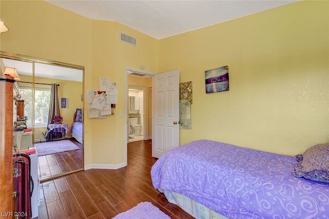 bedroom with a closet and dark wood-type flooring