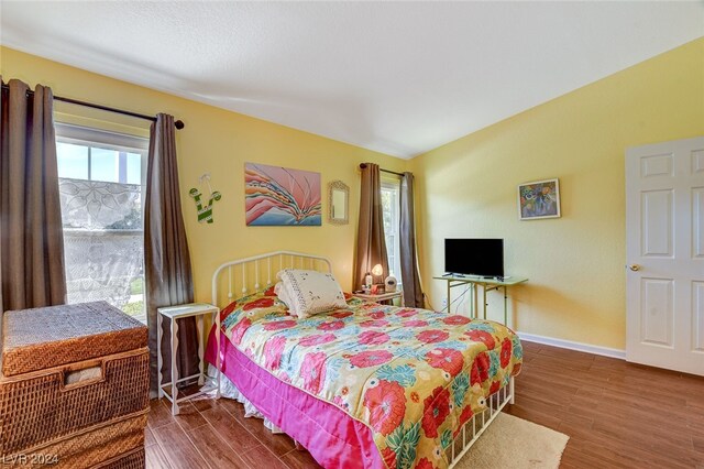 bedroom featuring dark hardwood / wood-style flooring