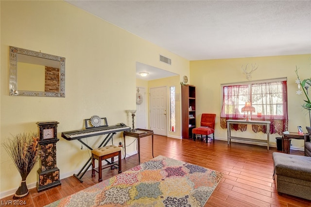 interior space featuring hardwood / wood-style floors and vaulted ceiling