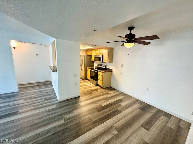 unfurnished room with a textured ceiling, ceiling fan, and light wood-type flooring