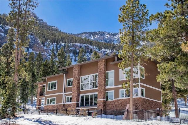 snow covered property featuring a mountain view