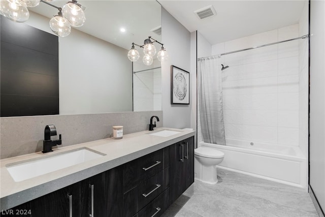 full bathroom featuring dual sinks, oversized vanity, shower / tub combo, tile flooring, and toilet