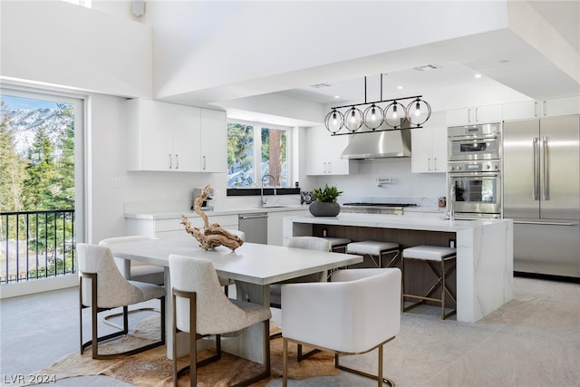 kitchen with plenty of natural light, stainless steel appliances, a breakfast bar, and a center island