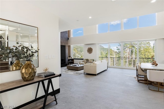 living room featuring a towering ceiling