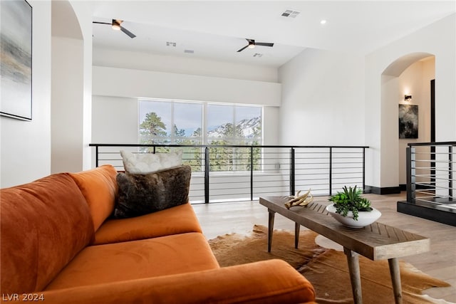 living room with ceiling fan and light hardwood / wood-style floors