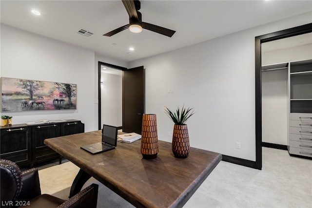 carpeted office space featuring ceiling fan