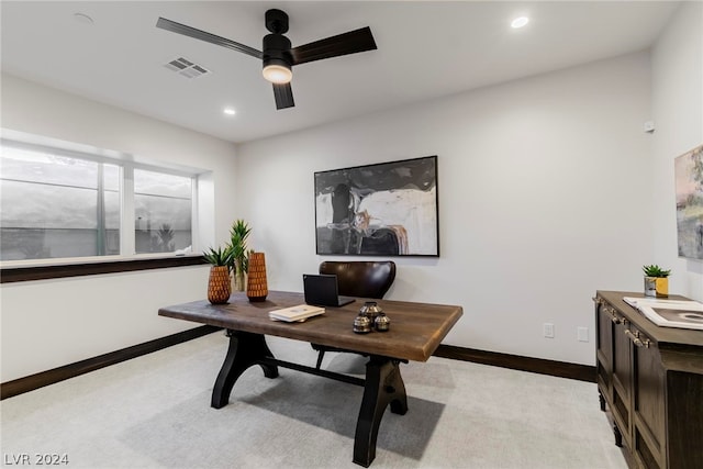 carpeted office space with ceiling fan