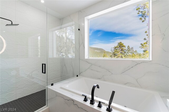 bathroom featuring separate shower and tub