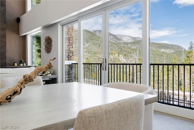 sunroom / solarium featuring a mountain view and a wealth of natural light