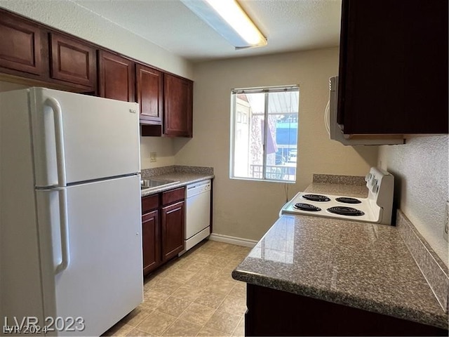 kitchen with light tile floors, white appliances, and sink