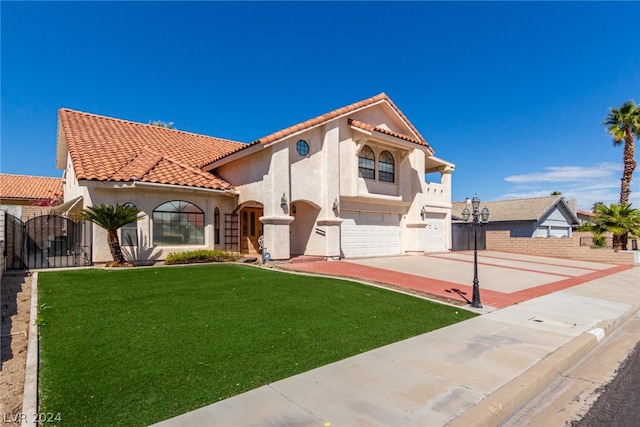 mediterranean / spanish-style house with a front yard and a garage