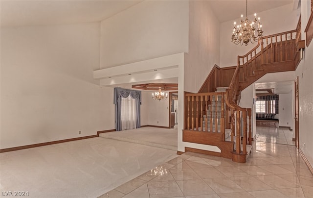 staircase featuring a notable chandelier, light tile flooring, and high vaulted ceiling