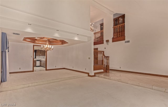 tiled empty room featuring a high ceiling, beam ceiling, a chandelier, and a raised ceiling