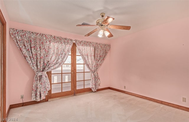 unfurnished room featuring light carpet and ceiling fan