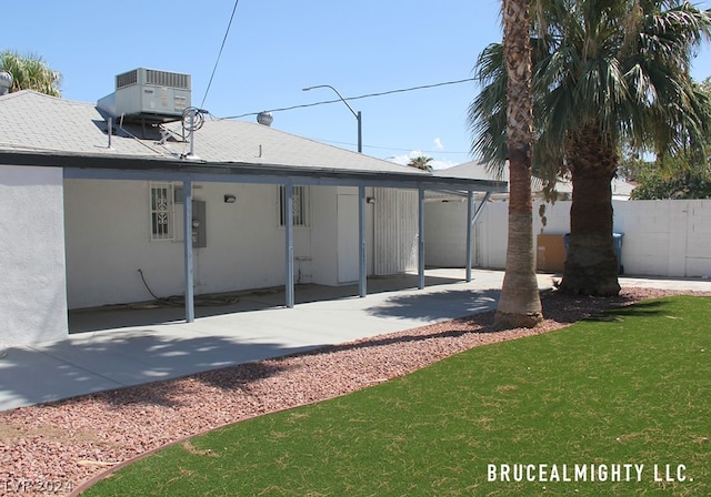 back of house with a yard and a patio area