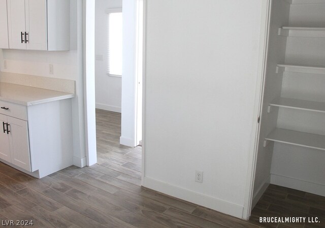 interior space featuring white cabinetry and hardwood / wood-style floors