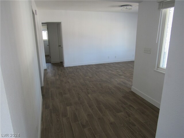 empty room with dark hardwood / wood-style flooring