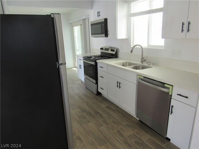 kitchen featuring white cabinets, dark hardwood / wood-style floors, sink, and stainless steel appliances