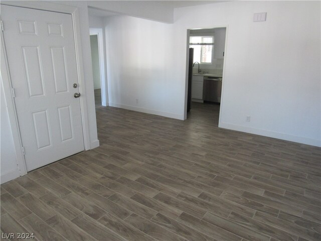 spare room with sink and dark hardwood / wood-style flooring