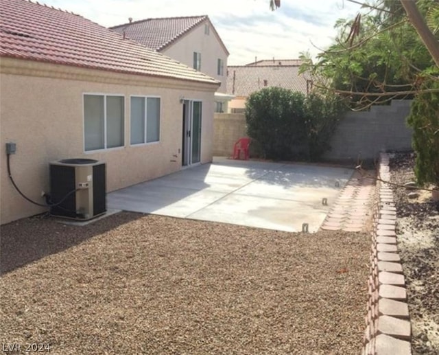 view of yard with central AC and a patio area