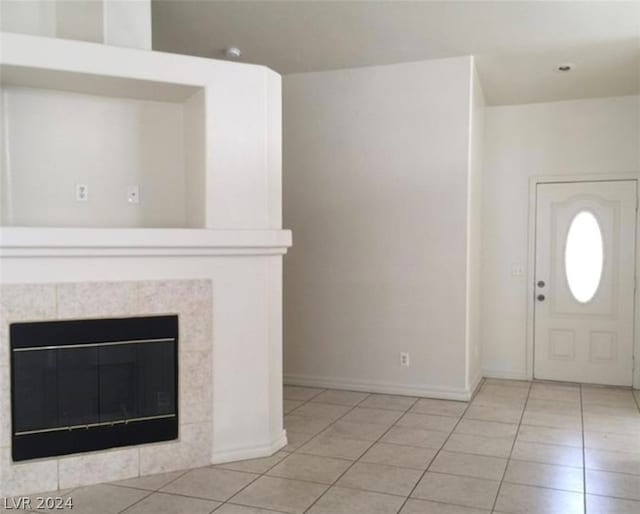 tiled entrance foyer with a tiled fireplace