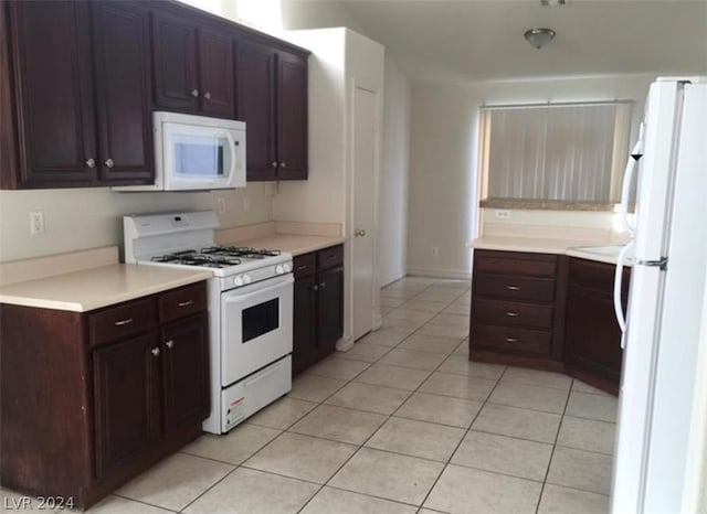 kitchen with white appliances, light tile floors, and dark brown cabinets