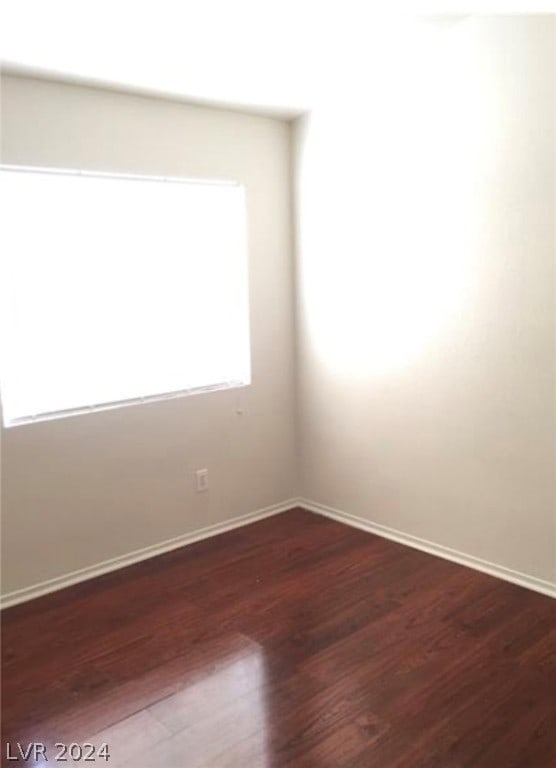 spare room featuring dark hardwood / wood-style flooring