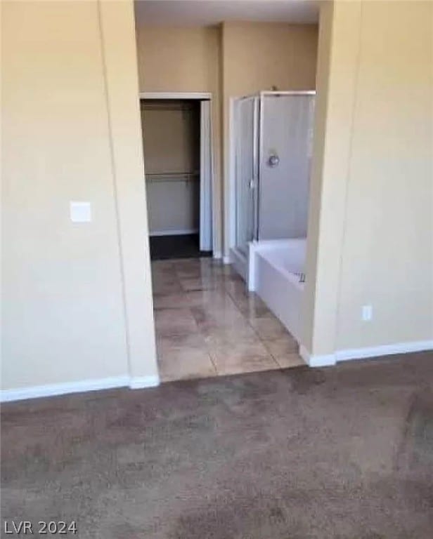 interior space with tile floors and a bath