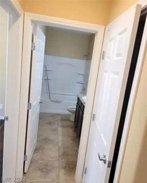 full bathroom featuring tile floors, toilet, vanity, and bathtub / shower combination