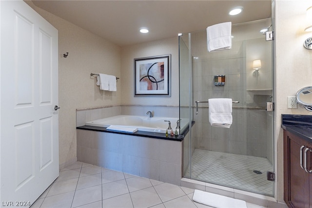 bathroom with shower with separate bathtub, vanity, and tile floors