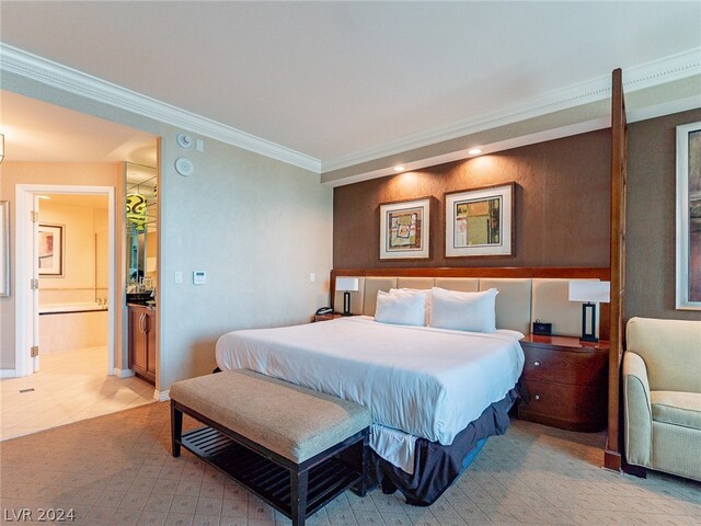 bedroom featuring tile floors, ornamental molding, and ensuite bath